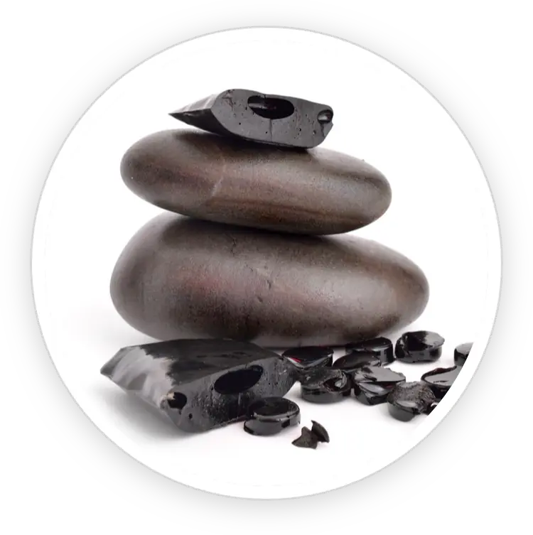 Stacked dark stones with black resin pieces, representing purified mountain resin.